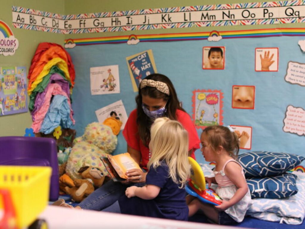 Women and children in a classroom