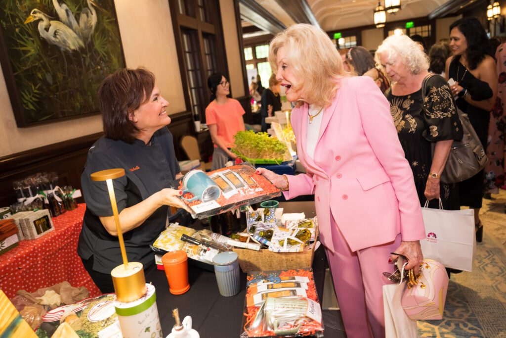 Women discussing items at a raffle table