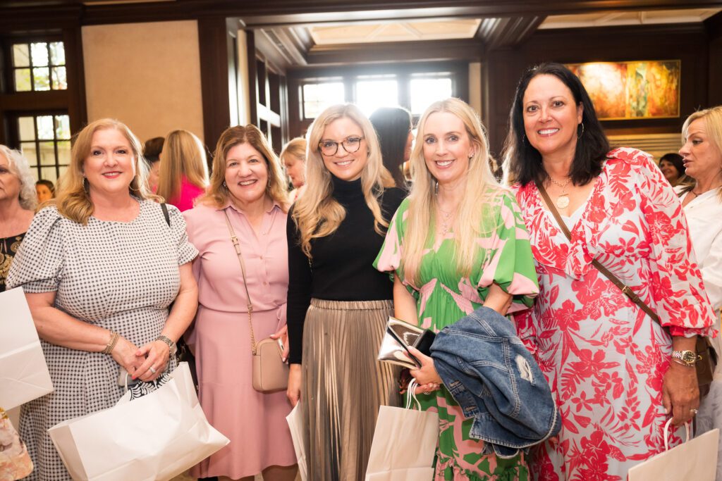 Group of women in an atrium smiling