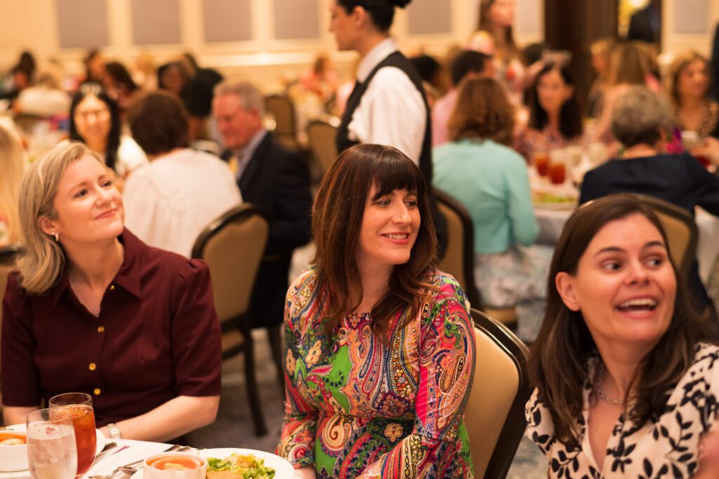 Women at a luncheon table looking to the right