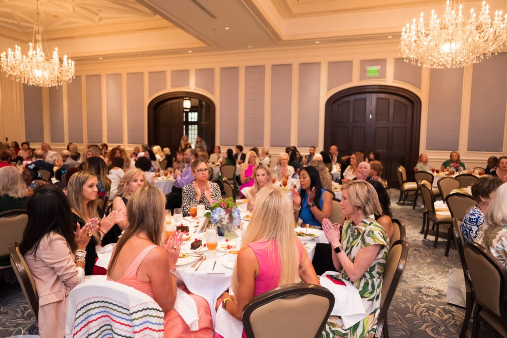 Group of luncheon attendees in a ballroom