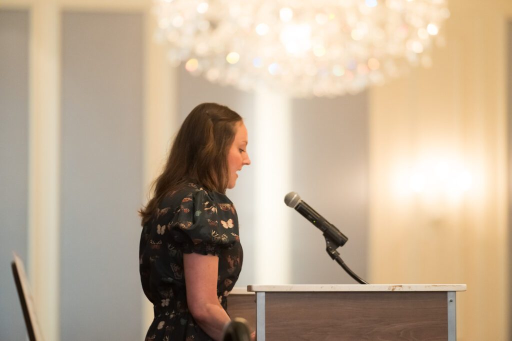 Woman speaking into a microphone