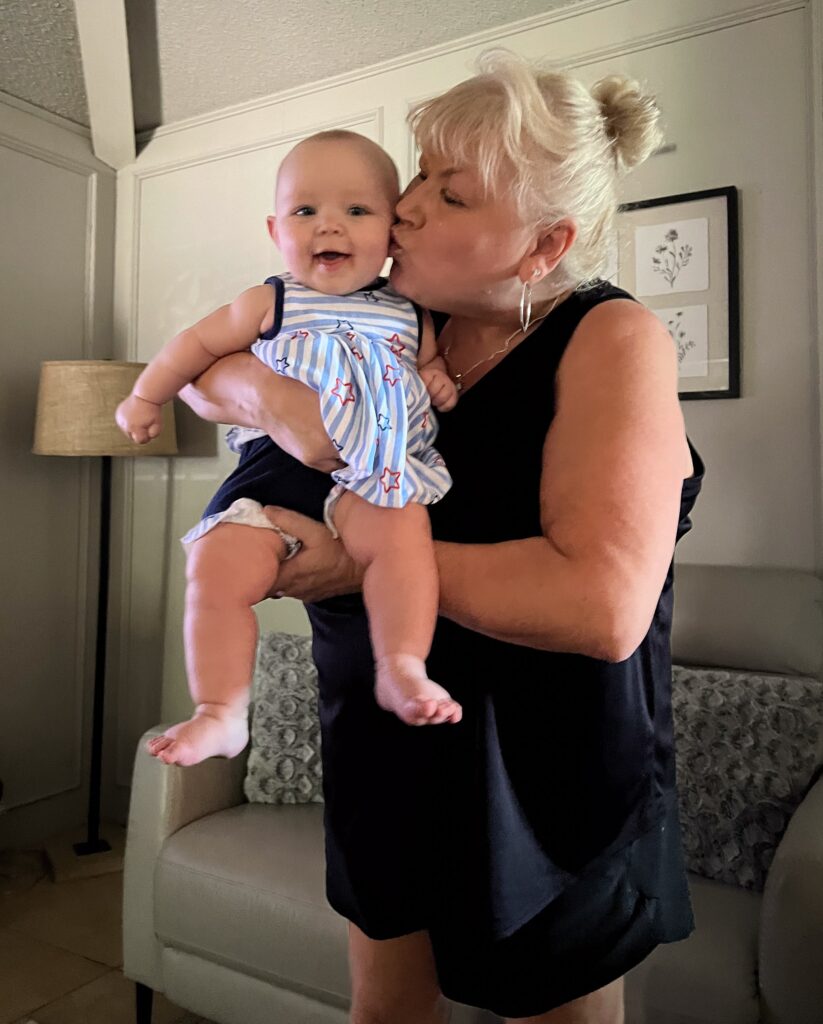 woman kissing grandbaby on cheek