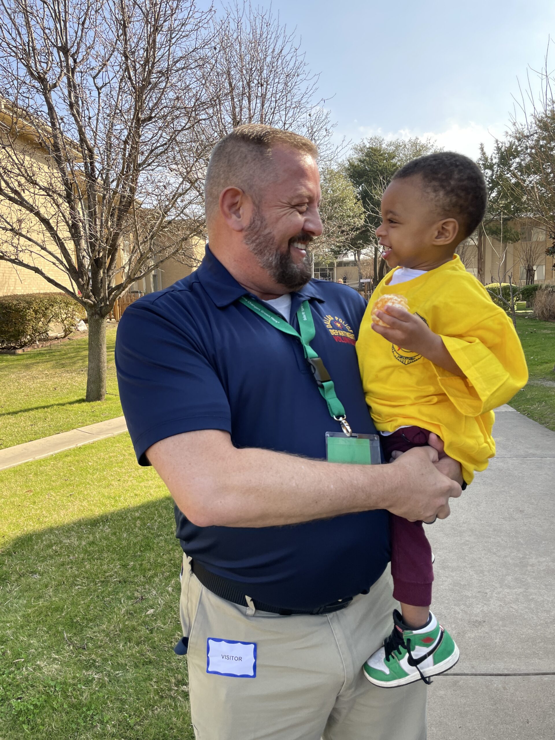 Dallas police officer holding small boy