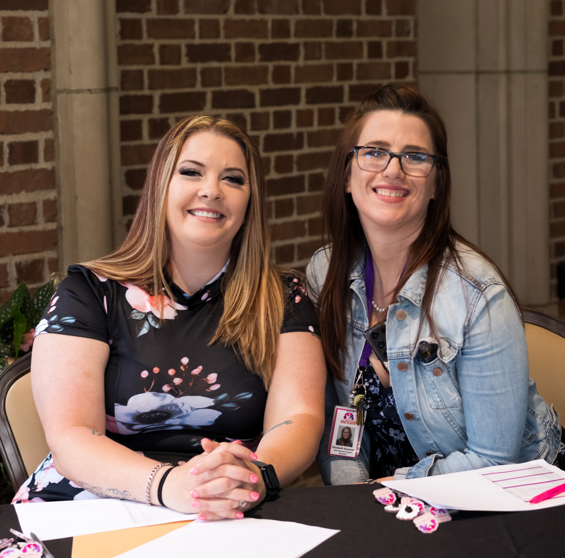 two volunteers at table
