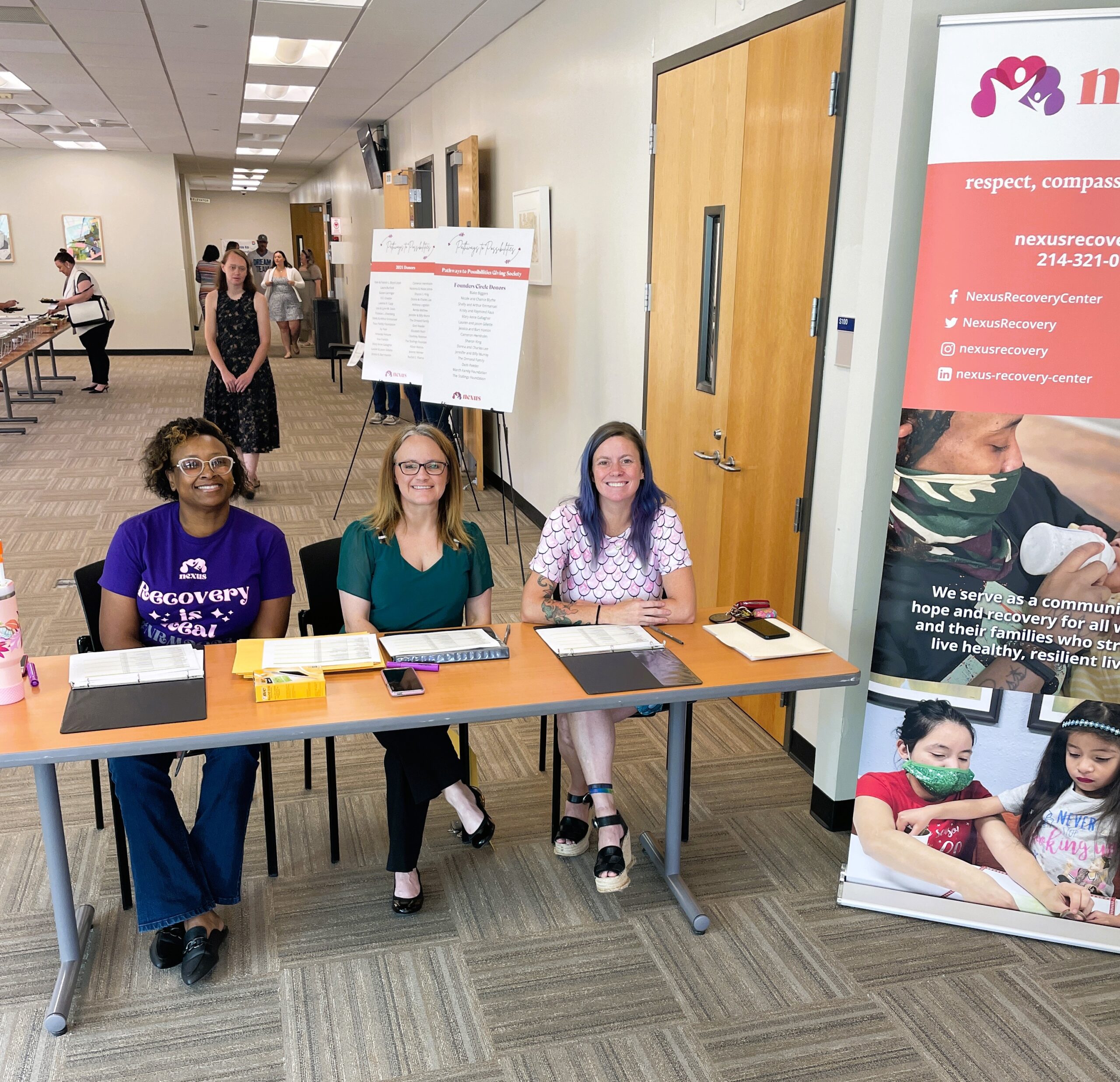 three volunteers at a table